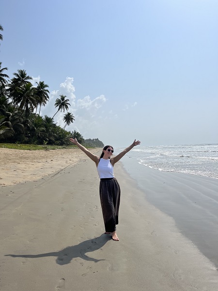 Graduating behavioral health counseling senior Rebecca Burke standing on the beach in Ghana. 